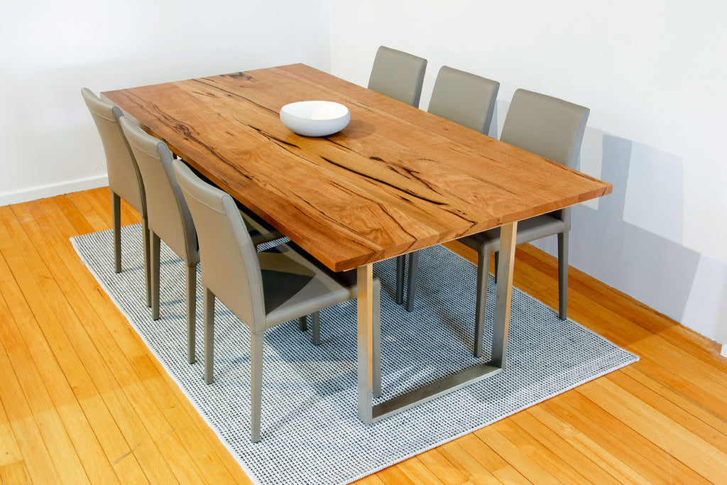 Mondo Marri Dining Table with Stainless Steel Base shown with leather dining chairs